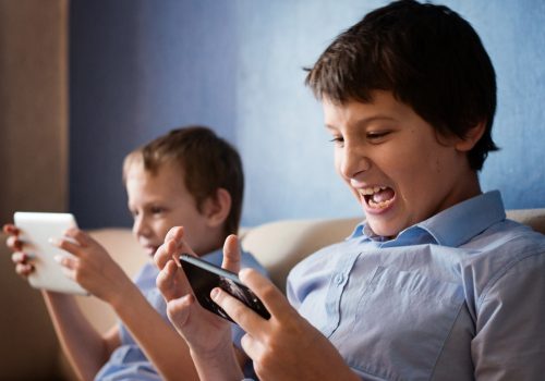 Children play mobile games on gadgets